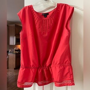 Coral sleeveless blouse with peplum
